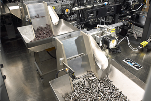 two feeders a part of an automated system with many small metal products being fed